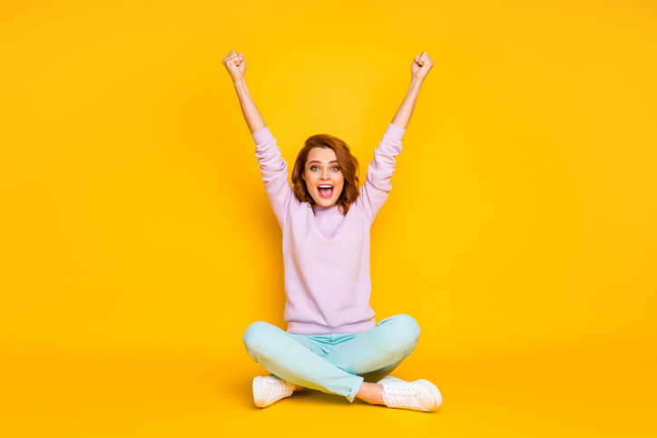 Happy person celebrating financial wellness success